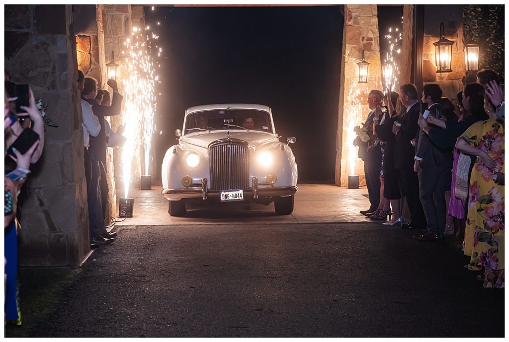 Bride and groom with Bentley get away car 