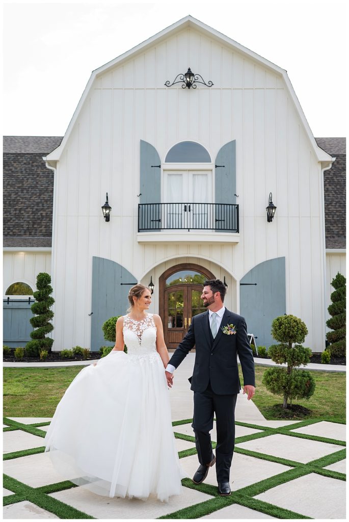 bride and groom in front of French Farmhouse