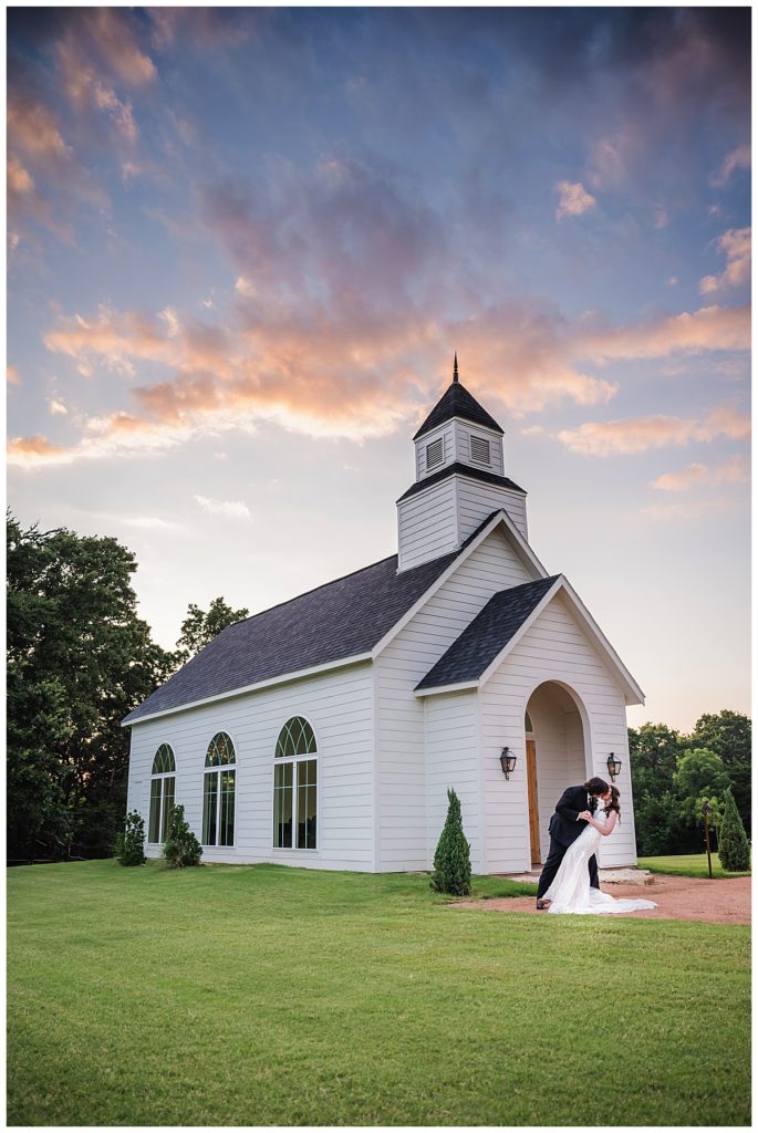 Bride and Groom with chapel at Thistle Hill Estate in Whitesboro